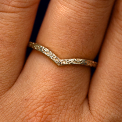 Close up view of a model's fingers wearing a 14k champagne gold Chevron Filigree Band