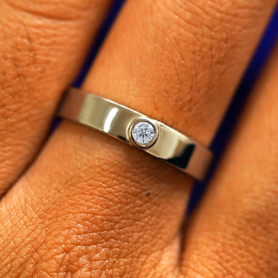 Close up view of a model's fingers wearing a 14k champagne gold Diamond Industrial Band