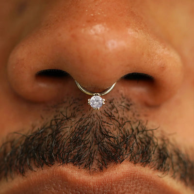 Close up view of a model's face wearing a 14k solid champagne gold Diamond Septum