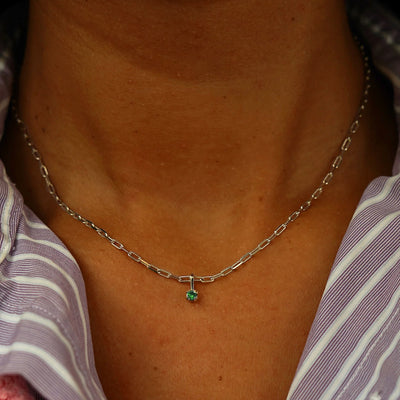 Close up view of a model's neck wearing a champagne gold Emerald Charm on a Butch Chain