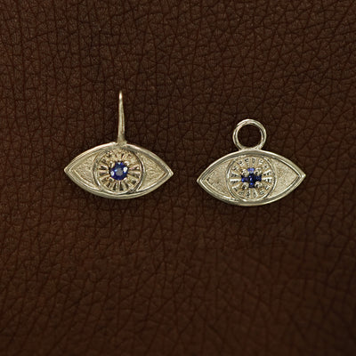 Two 14 karat Champagne gold blue sapphire Evil Eye Charms shown in the For Chain and For Earring options