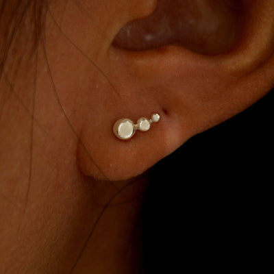 A model's ear wearing a solid champagne
gold Graduated Ball Earring
