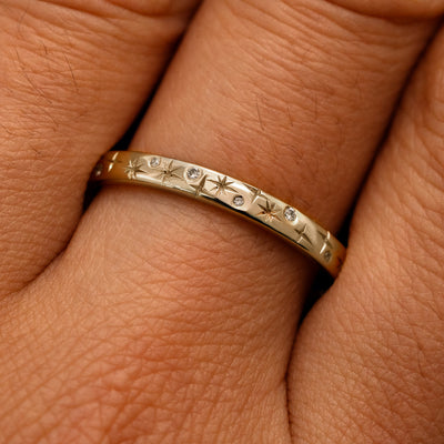 Close up view of a model's fingers wearing a 14k champagne gold Mixed Diamond Stars Band