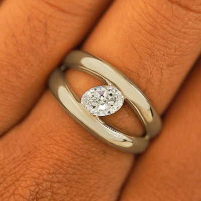 Close up view of a model's fingers wearing a 14k champagne gold Oval Lab Diamond Tension Ring