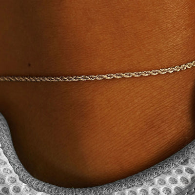 Close up view of a model's ankle wearing a champagne gold Rope Anklet