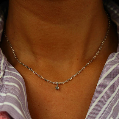Close up view of a model's neck wearing a champagne gold Salt and Pepper Diamond Charm on a Butch Chain