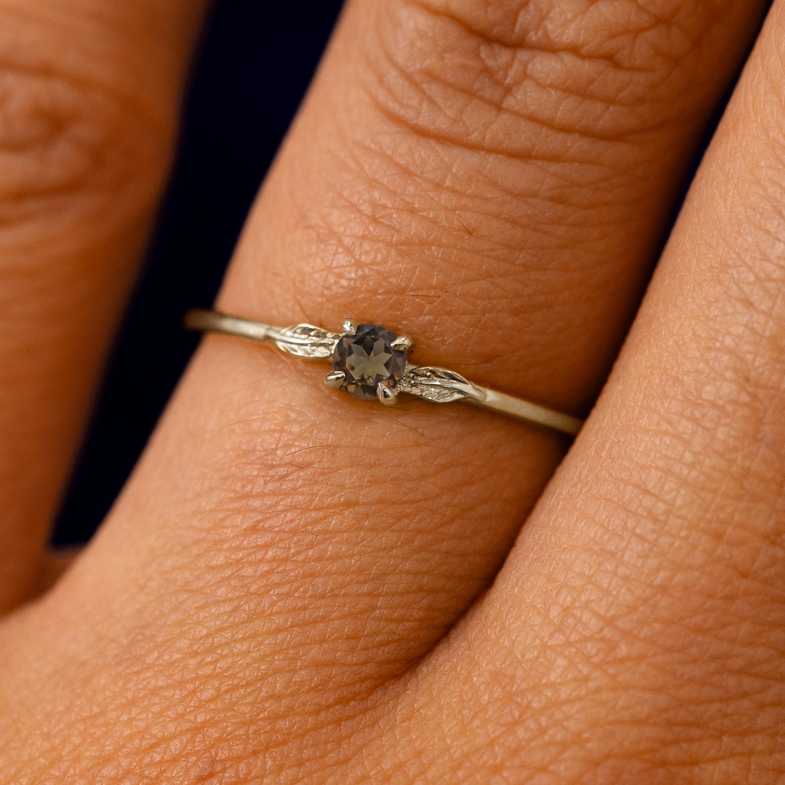 A solid 14k champagne gold Smoky Quartz Gemstone Two Leaf Ring on a model's finger