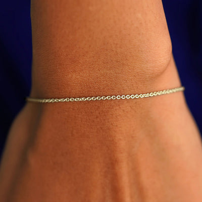 A model's wrist wearing a solid champagne gold Thick Cable Bracelet