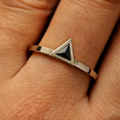 Close up view of a model's hand wearing a solid 14k champagne gold Triangle Diamond Ring