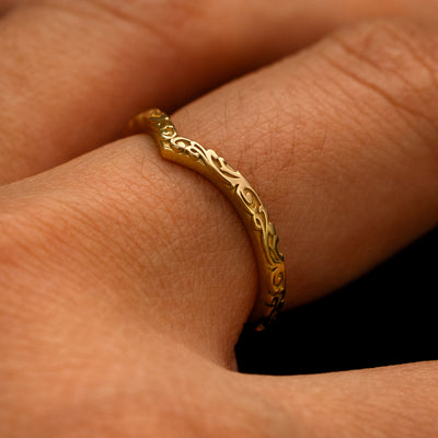 Side view of a Chevron Filigree Band on a model's finger