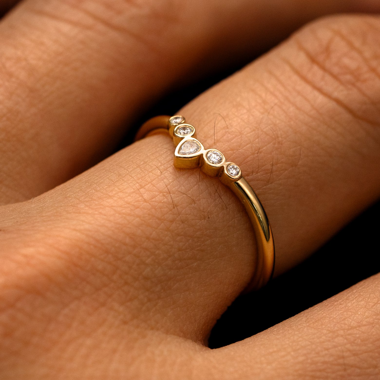 Side view of a Chevron Tiara Diamond Band on a model's finger