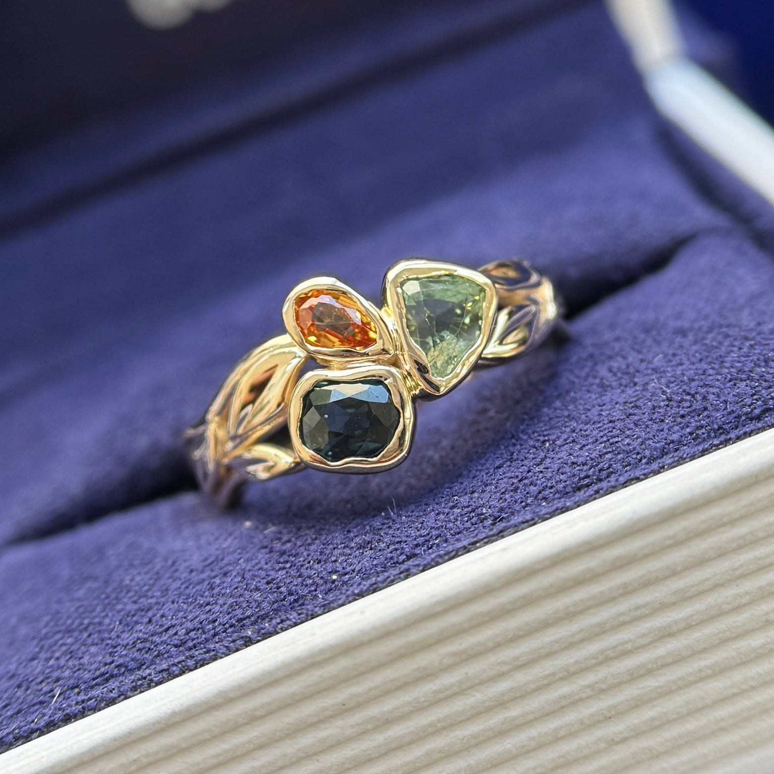 front of 14k Yellow Gold and Melted-bezel 1.20ct Nature colors Sapphires 3-stone on Polished Leaves and Branches Band Custom Ring, size 6.25
