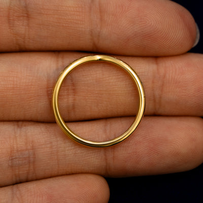 A Curvy Chevron Diamond Stars Band lying flat in a models hand to show the thickness of the Ring