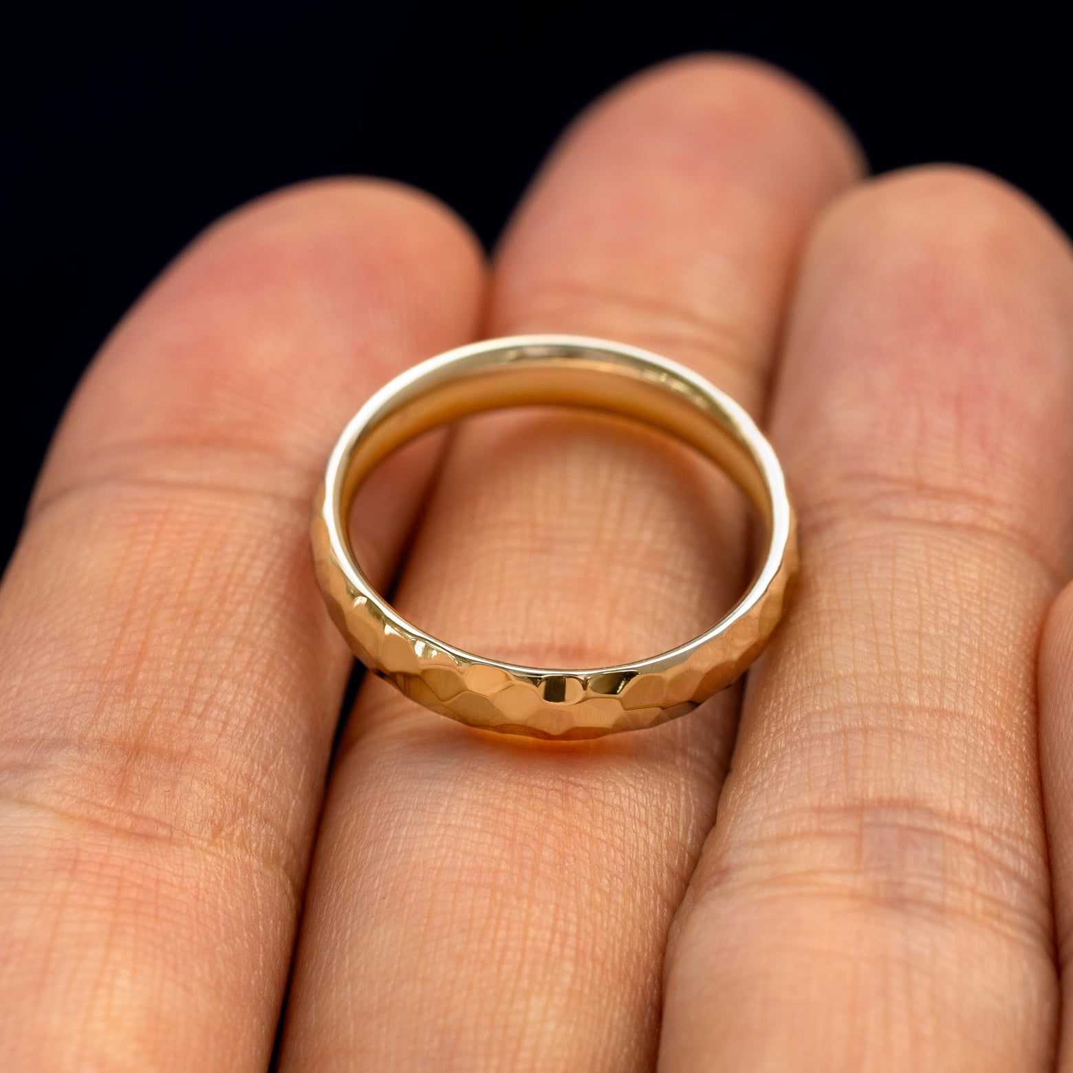 A Curvy Hammered Band in a model's hand 