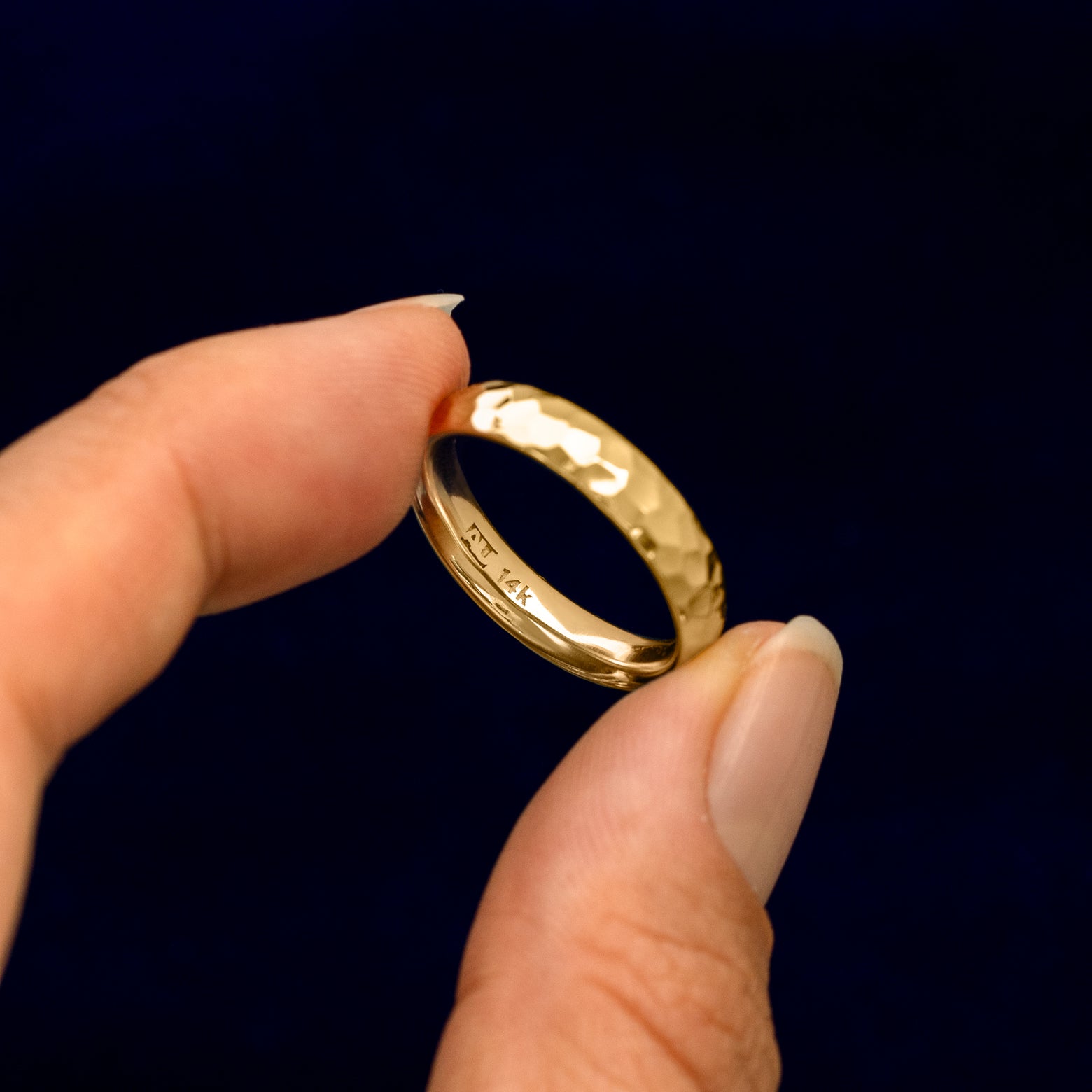 Underside view of a solid 14k gold Curvy Hammered Band