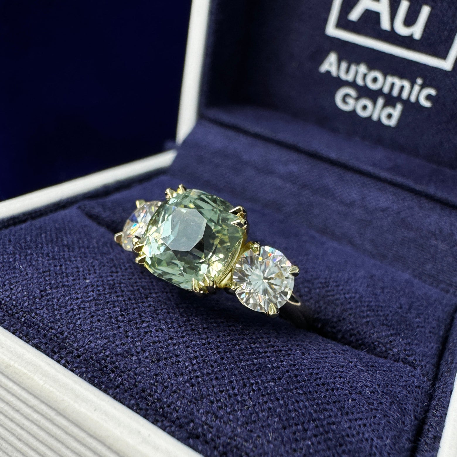 14k Yellow Gold Bezel-set 3.17ct Customer’s Cushion Sapphire w/ 2pc 5mm Round Moissanites on 2mm Curvy Band Custom Ring