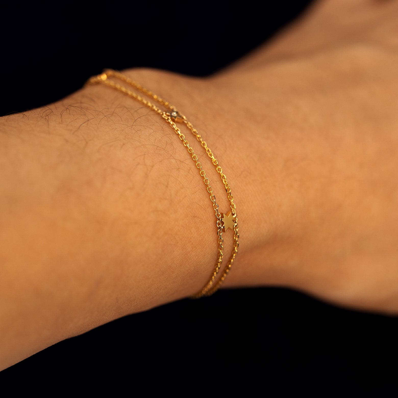 A model wearing an 8 pointed star bracelet to show the chain details