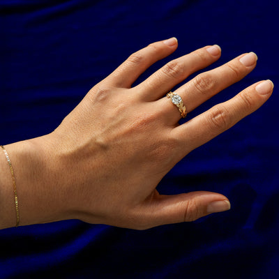 Full view of a model's fingers wearing a 14k yellow gold Diamond Leaves Ring