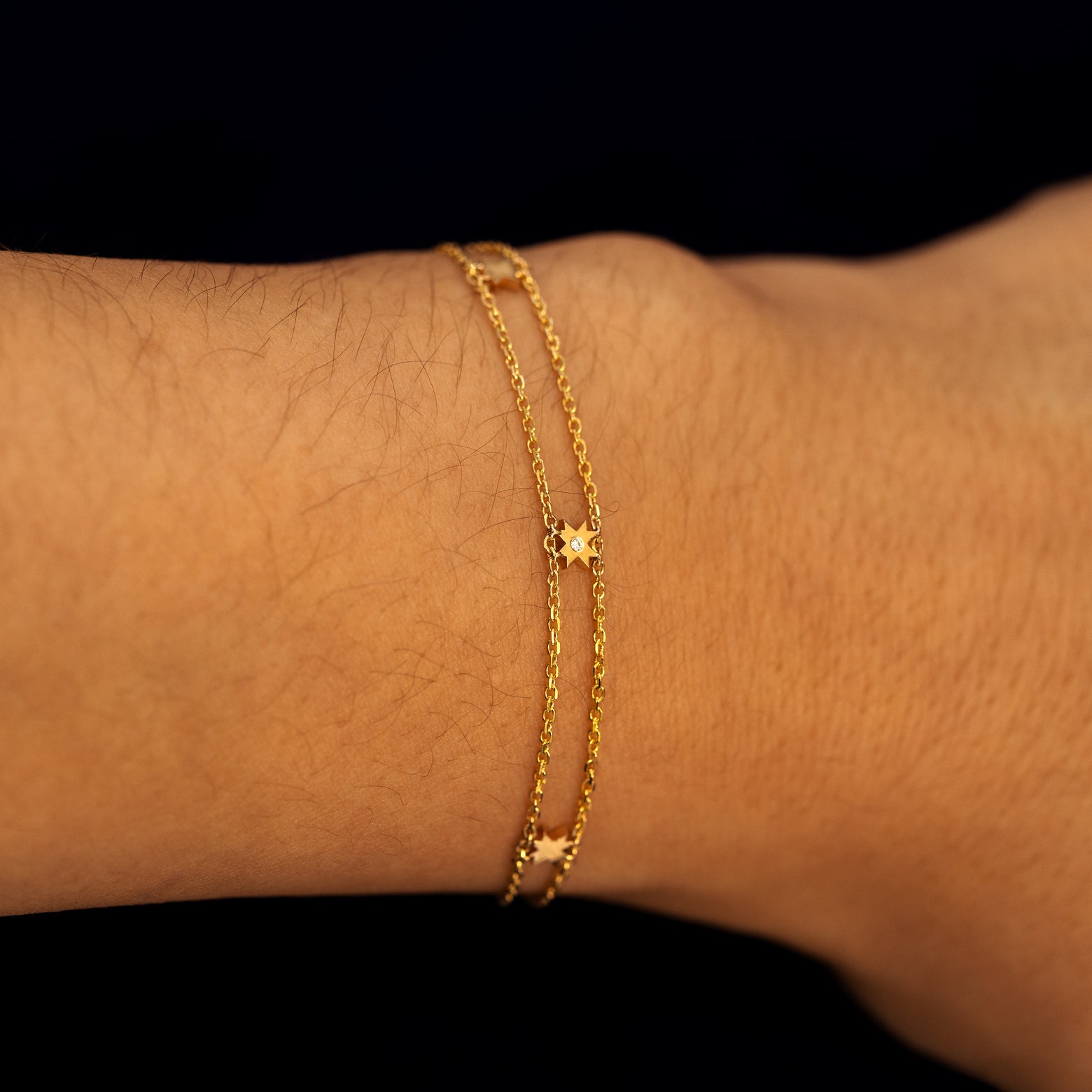A model wearing a double chain 8 pointed star station bracelet
