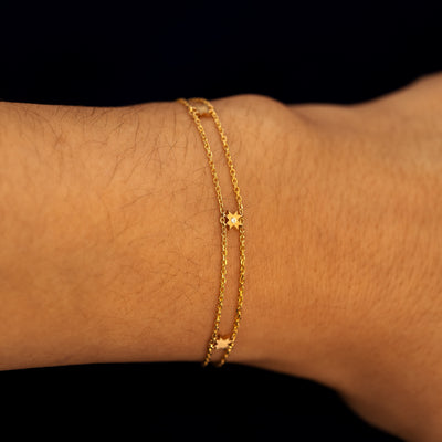 A model wearing a double chain 8 pointed star station bracelet