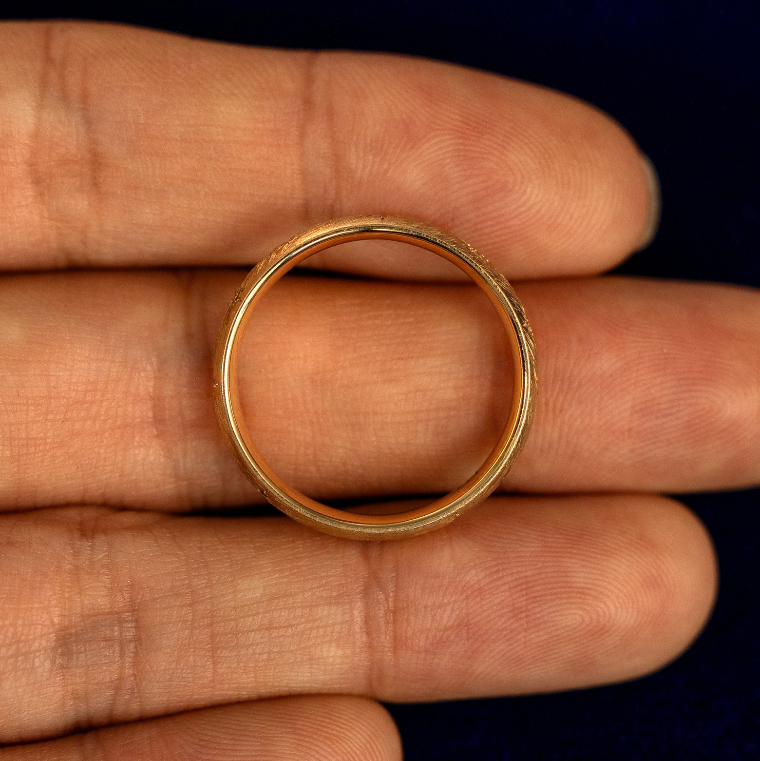 A Curvy Diamond Stars Velvet Band lying flat in a models hand to show the thickness of the Ring