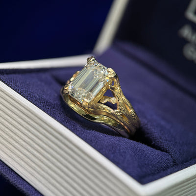 14k Yellow Gold and 3ct Emerald-cut Lab Diamond Leaves and Branches set Custom Ring and 14k Yellow Gold Mixed Mirror Band 2.5mm Custom Order Curving Around Engagement Ring, both in size 6.5