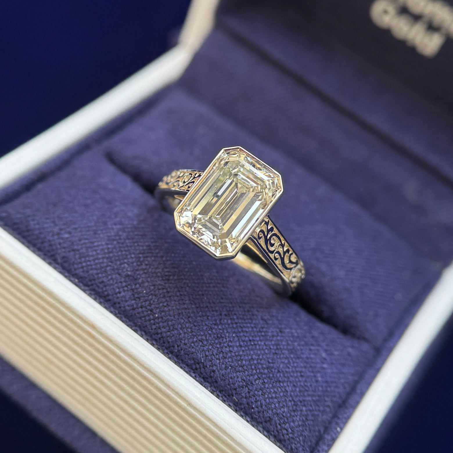front view of 14k Champagne Gold Cathedral-bezel-set 3ct Emerald Cut Lab Diamond on 3mm Industrial Filigree Band Custom Ring, Size 6