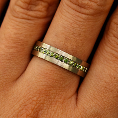 Close up view of a model's fingers wearing a 14k champagne gold Endless Green Diamond Band