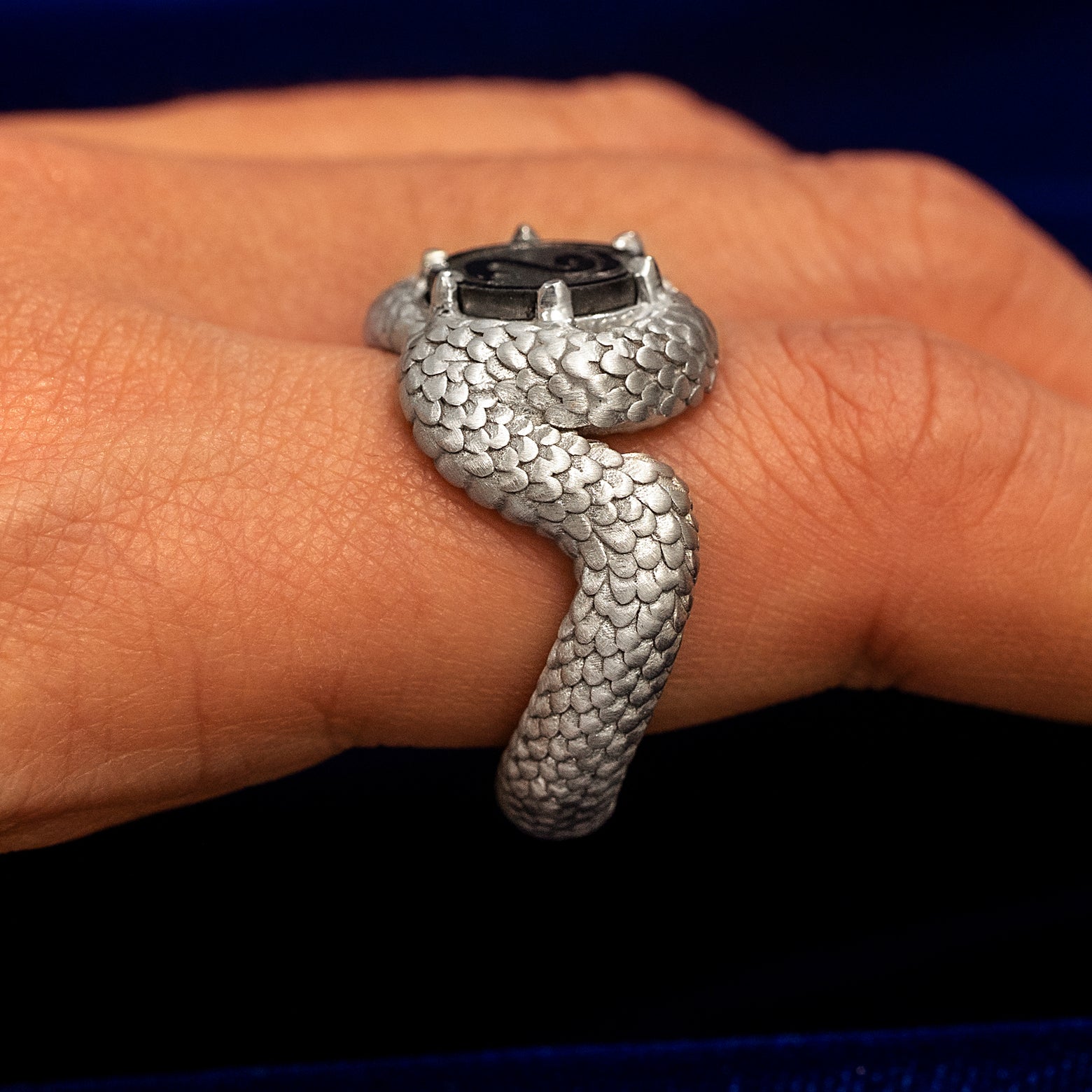 Side view of a Sterling Silver Engraved Black Diamond Snake Ring  on a model's finger