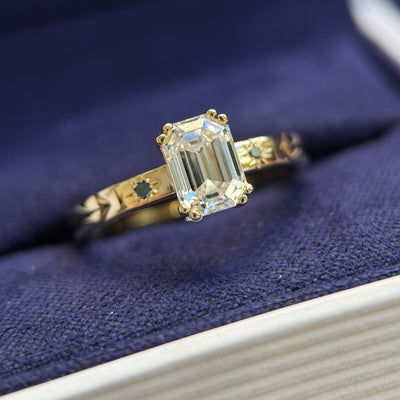 front view of 14k Yellow Gold and High-set 1ct Octagon Custom cut Lab Diamond with Blue and Green Round Small Diamonds on 2.5mm Etched Band Custom Ring, size 5.5