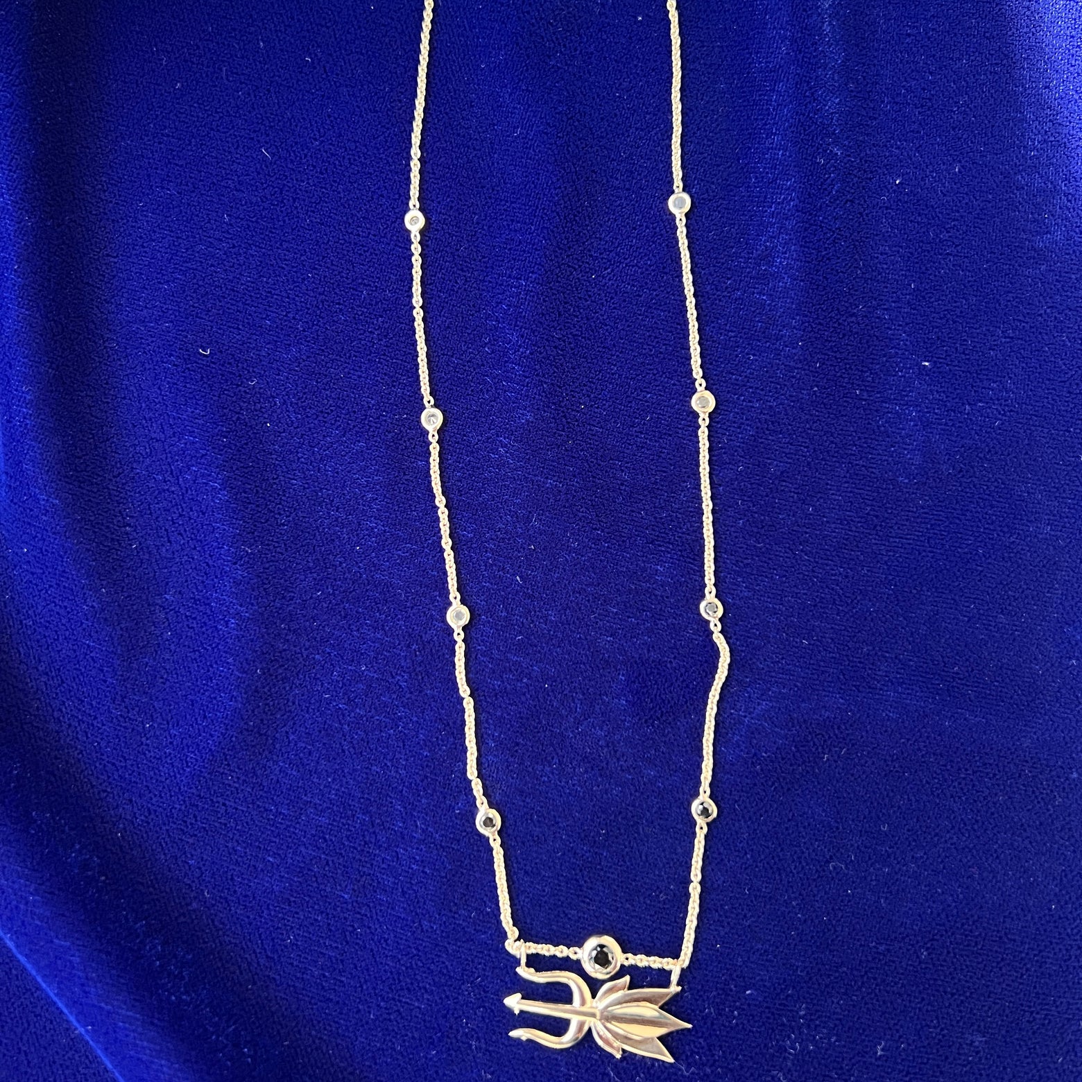 full view of necklace in with cut out pendant