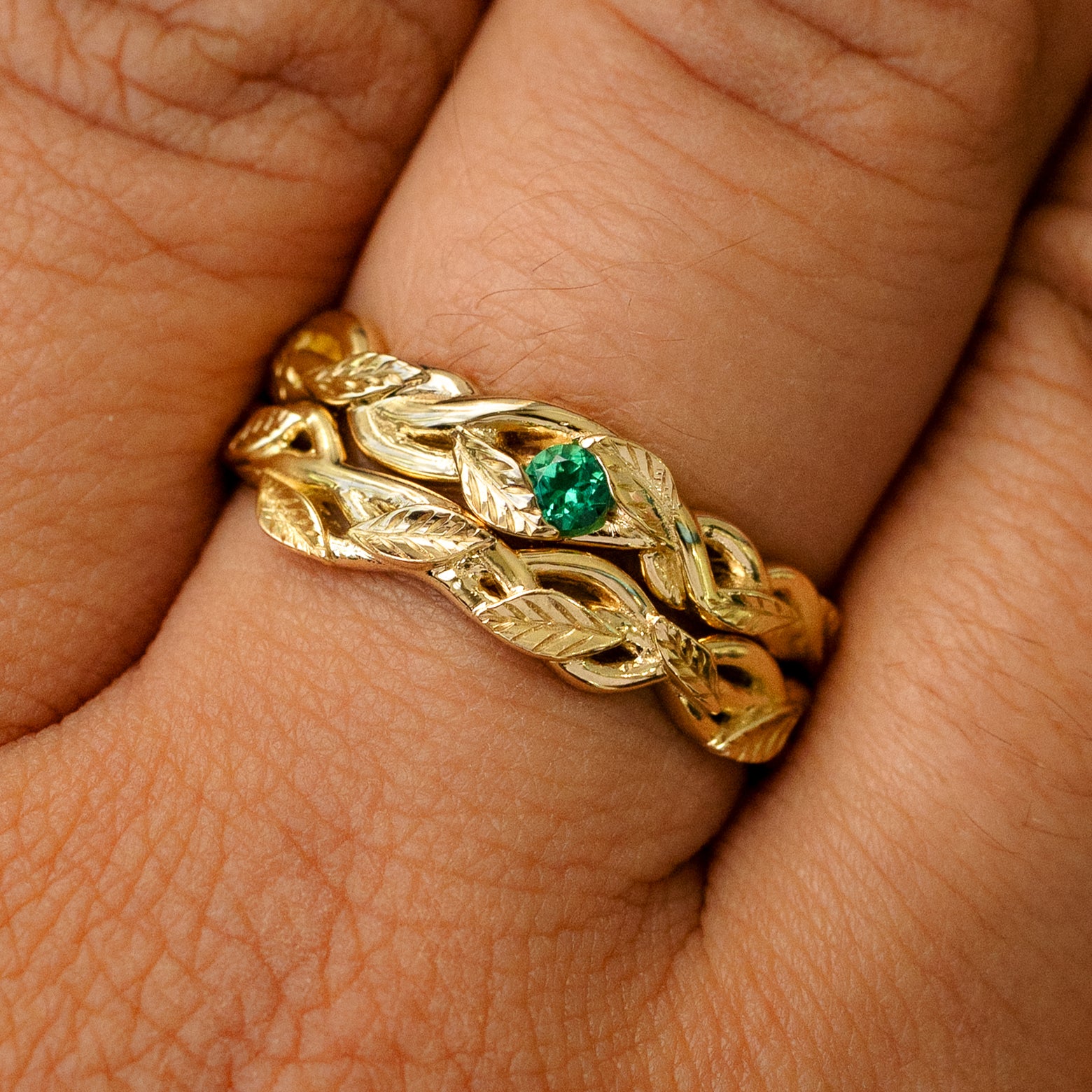 A Gemstone Leaves and Vines Ring stacked with a Braided Leaves and Vines Ring on a models finger