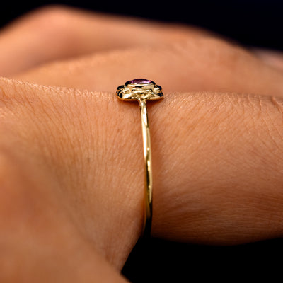 Side view of a Pink Sapphire Gemstone Flower Ring on a model's finger to show the detailing of the setting