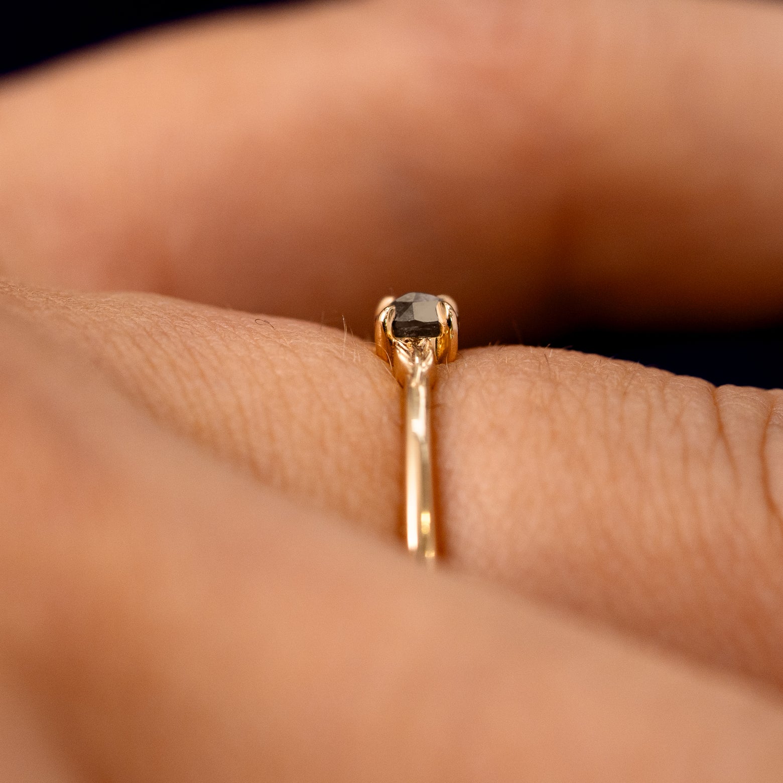 Side view of a Smoky Quartz Gemstone Two Leaf Ring on a model's finger to show the detailing of the setting