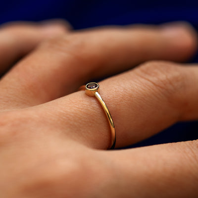 Side view of a Garnet Ring on a model's finger