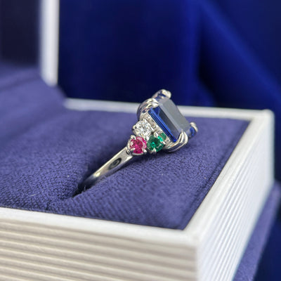 14k White Gold with Low-set Emerald-cut 6x8mm Blue Lab Sapphire with 2.5mm Round Lab Ruby, Lab Emerald, Moissanite with hidden Orange Engraved Custom Ring