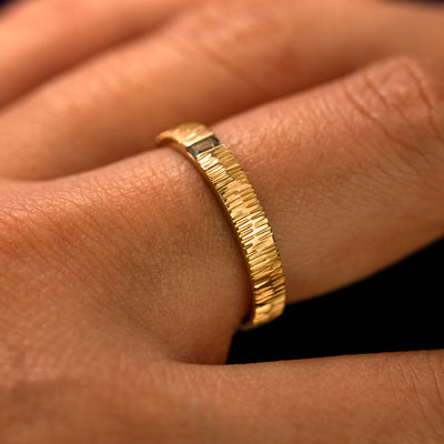 Side view of a Baguette Green Sapphire Wood Band on a model's finger