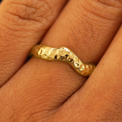 Close up view of a model's fingers wearing a 14k Hammered Liquid Band