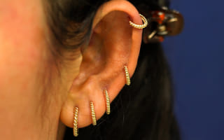Close up view of a model's ears wearing four Rope Huggie Hoops in four different piercings