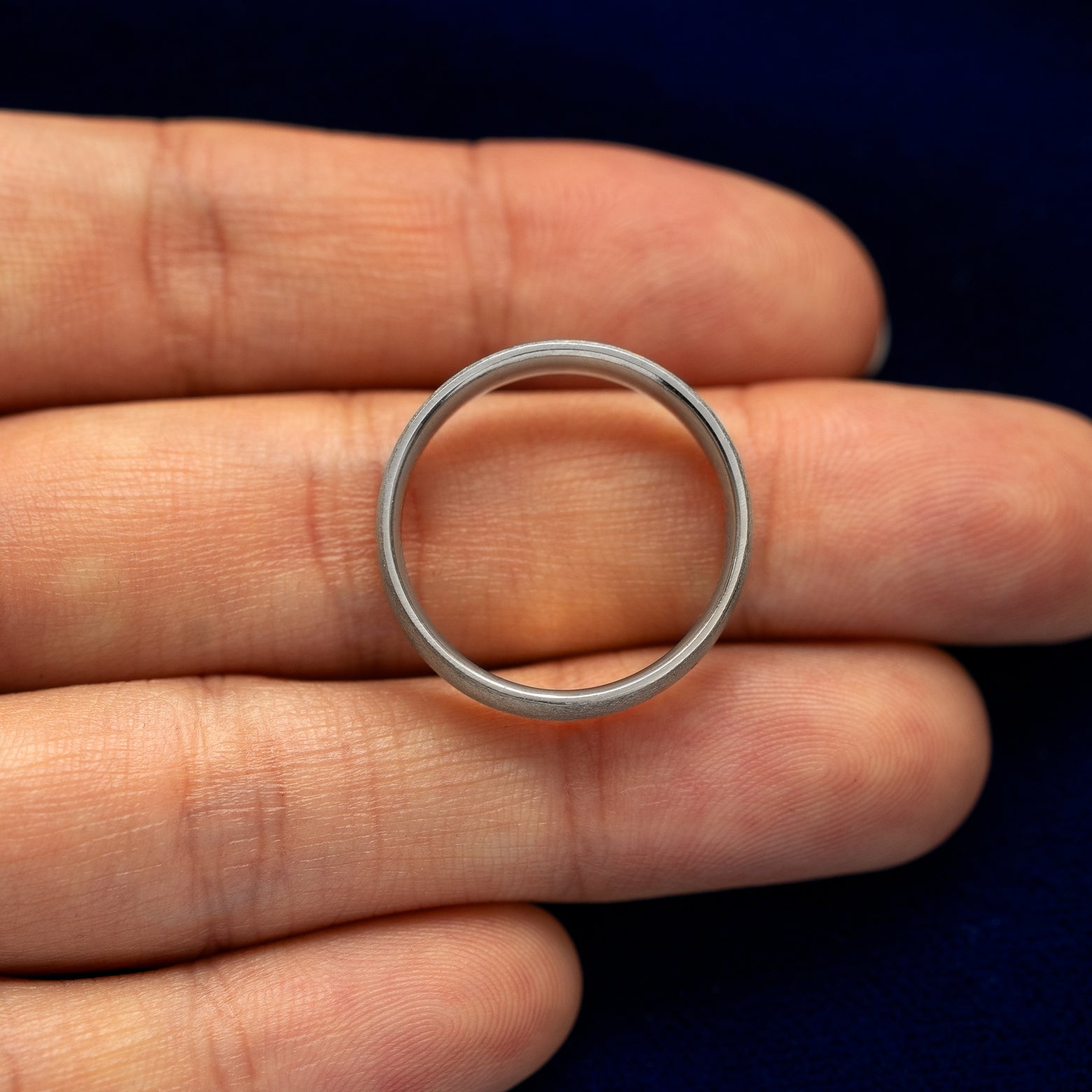 A 925 Silver Industrial Matte Band resting on a model's fingers to show the thickness of the band
