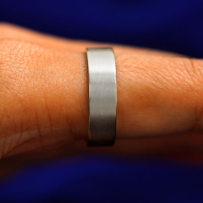 Side view of a Silver Industrial Matte Band on a model's finger