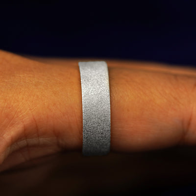 Side view of a Sterling Silver Industrial Stardust Band on a model's finger