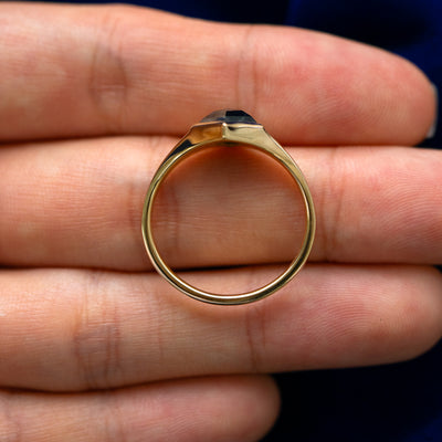 A 14 karat solid gold Journey Ring lying on a model's fingers to show the thickness of the band