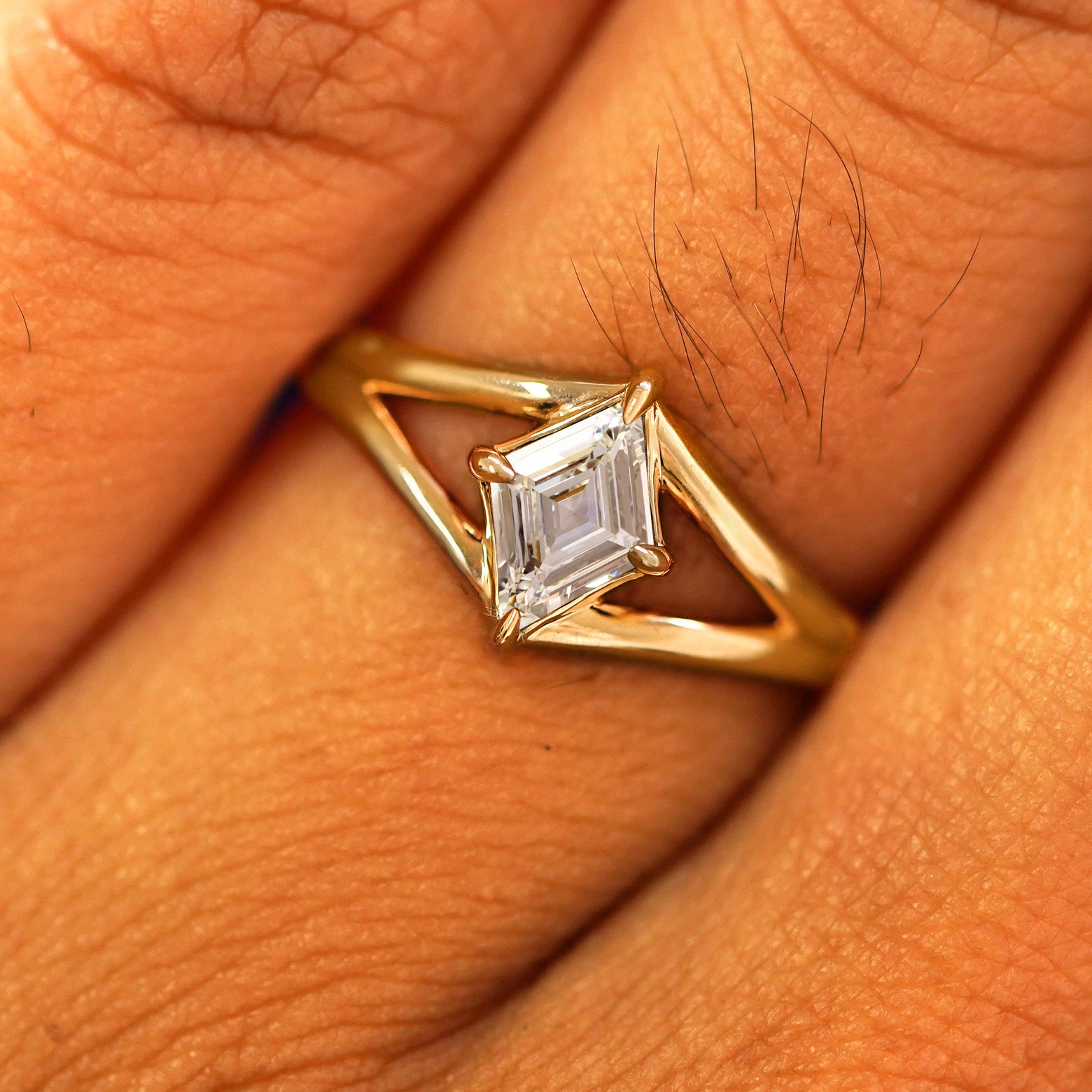 Close up view of a model's fingers wearing a 14k yellow gold Lab Diamond Kite Ring