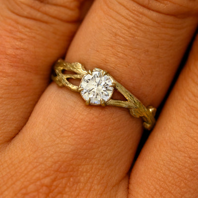 Close up view of a model's fingers wearing a 14k yellow gold Lab Diamond Branches Ring