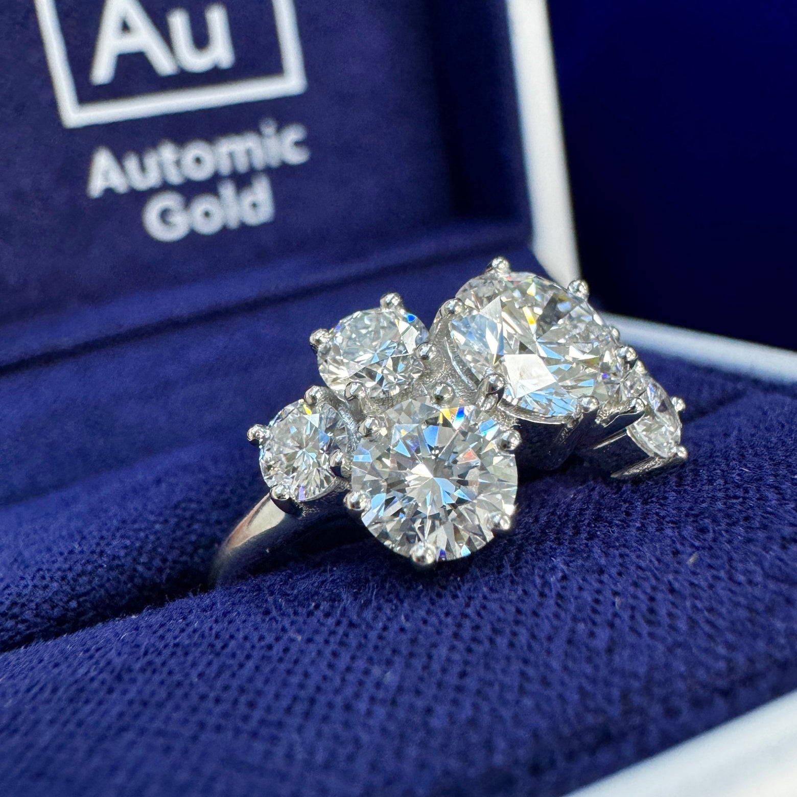 Lab diamond cluster ring in a blue ring box