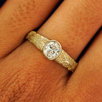 Close up view of a model's fingers wearing a 14k yellow gold Lab Diamond Pine Ring