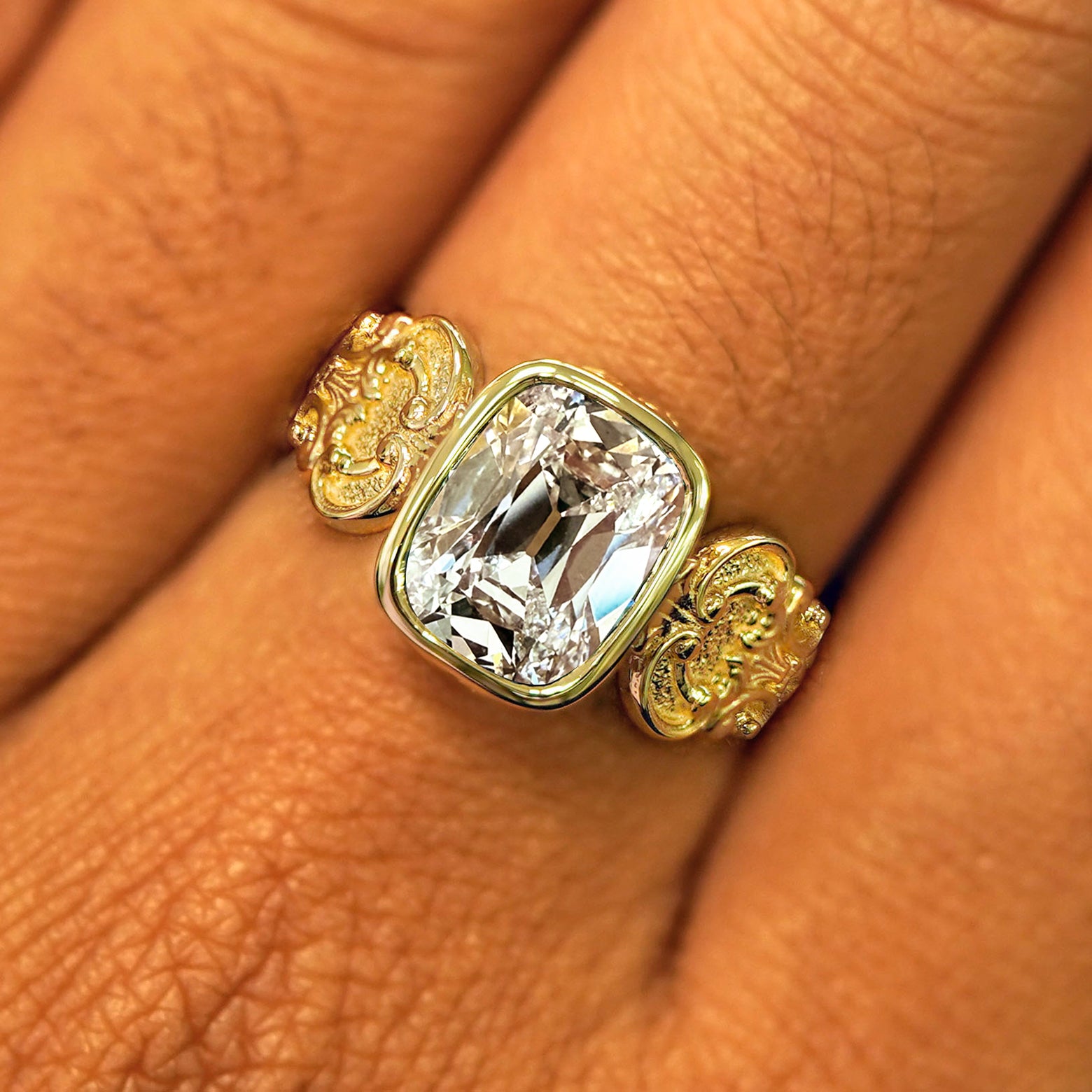 Close up view of a model's fingers wearing a yellow gold lab diamond Royalty Ring