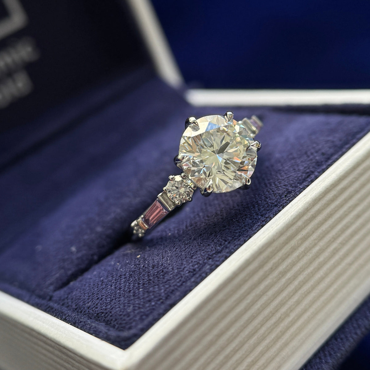 950 Platinum Claw-prongs-low-set 2.5ct Round Lab Diamond with 4pcs Round Lab Diamonds and 2pcs Tapered Baguette Sapphires on 2mm Curvy Mirror Band Custom Ring, Size 6.25