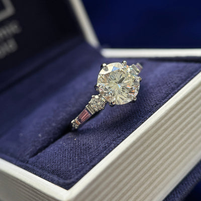 950 Platinum Claw-prongs-low-set 2.5ct Round Lab Diamond with 4pcs Round Lab Diamonds and 2pcs Tapered Baguette Sapphires on 2mm Curvy Mirror Band Custom Ring, Size 6.25